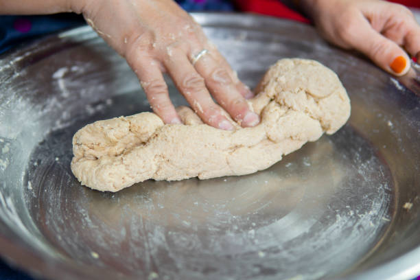 istock Close-up of hands kneading wheat dough. 1271558780