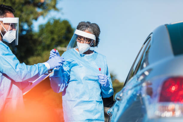 istock After testing car driver, nurse hands vial to colleague 1271559830