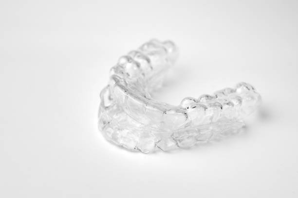 istock Invisible orthodontic removable braces on a white background with copy space. Aligners for straightening of teeth. 1271560075