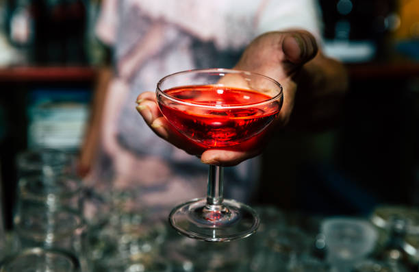 istock barman offering cocktail drinks on bar counter 1271561386