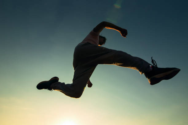 istock A man running and jump in the air. 1271561544
