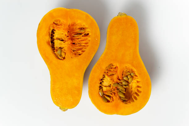 istock Sliced pumpkin with seeds and pulp on a white background. 1271563828
