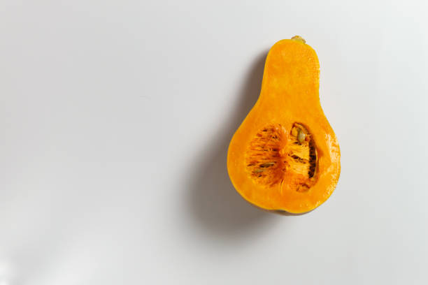 istock Sliced pumpkin with seeds and pulp on a white background. 1271563833
