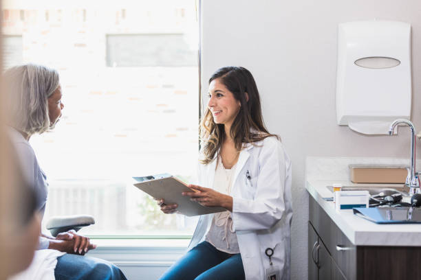 istock Doctor smiles while talking to senior patient 1271564193