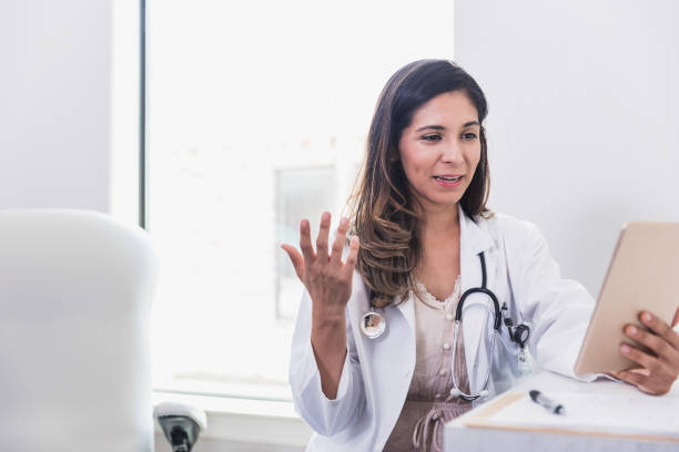 istock Doctor talks with patient during telemedicine appointment 1271564739
