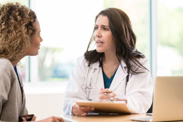 istock Concerned doctor discusses patient's health 1271564784
