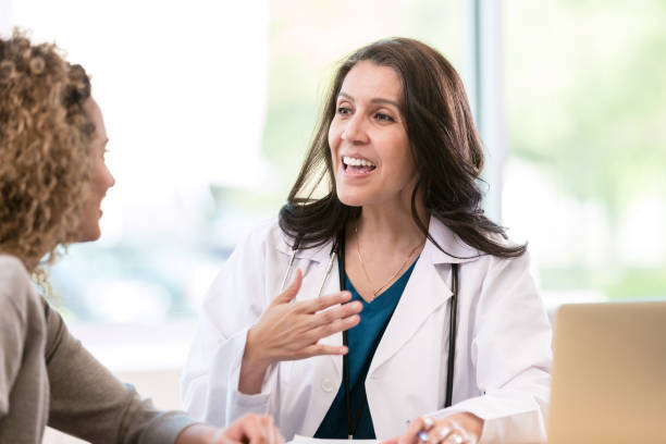 istock Confident mature doctor talks with female patient 1271564785