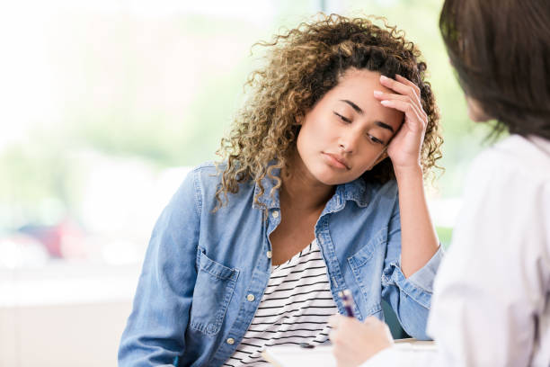 istock Upset young woman talking with therapist 1271564882