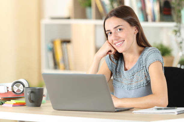 istock Happy student posing looking at camera at home 1271565382