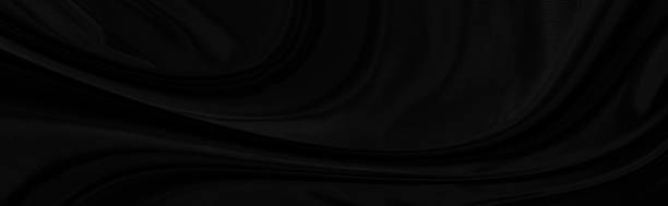 istock Black gray satin dark fabric texture luxurious shiny that is abstract silk cloth panorama background with patterns soft waves blur beautiful. 1271566610