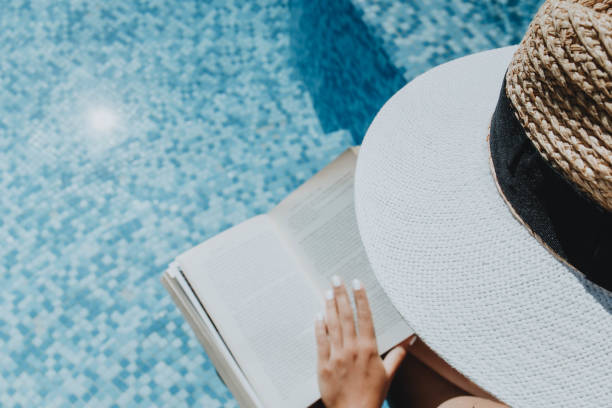 istock Woman with hat  reading a book 1271568371