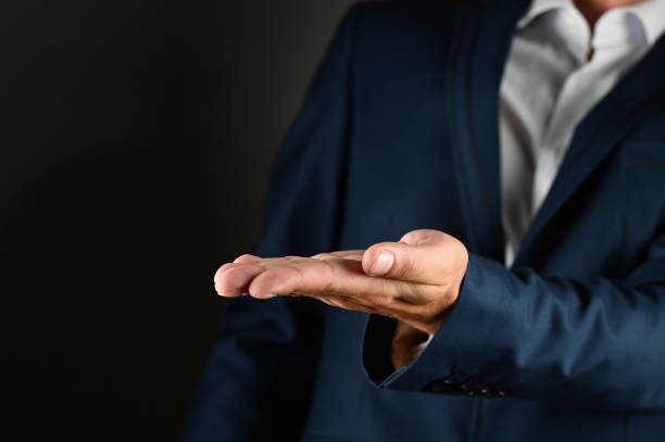 istock The man in the suit holds out his palm 1271568400