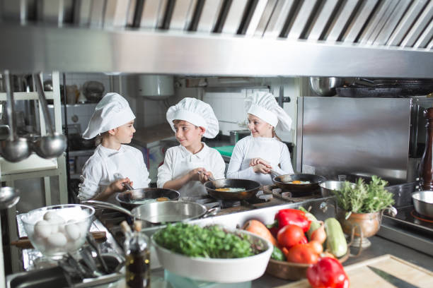 istock Children cook eggs in the kitchen at the Restaurant. 1271569325