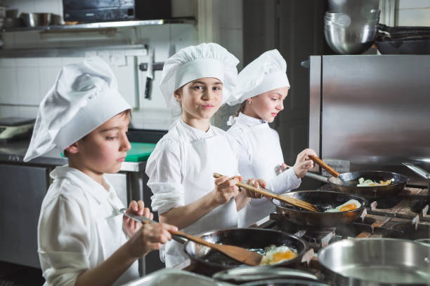istock Children cook eggs in the kitchen at the Restaurant. 1271569403