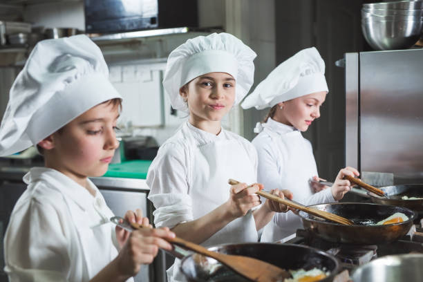 istock Children cook eggs in the kitchen at the Restaurant. 1271569419