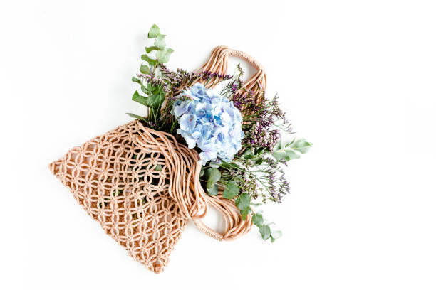 istock Beautiful bouquet of hydrangeas in a string, eco bag on white background. Flat lay, top view 1271570788