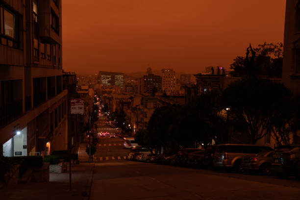 A dark smoke filled sky over San Francisco. Looking down Jones St. in Nob Hill in a dark orange sky during the day.