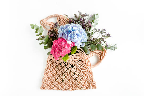 istock Beautiful bouquet of hydrangeas in a string, eco bag on white background. Flat lay, top view 1271570980