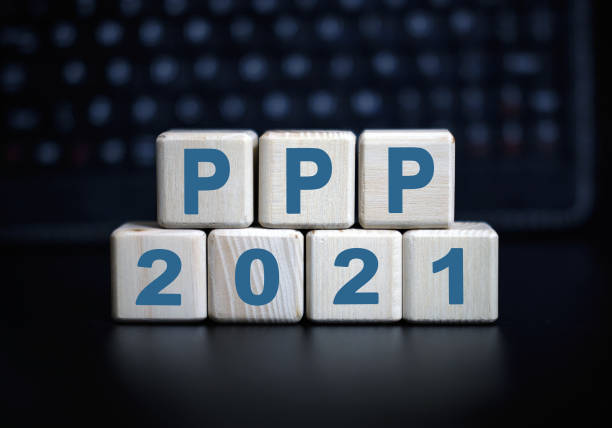 2021 concept - PPP text in wooden cubes on a black keyboard