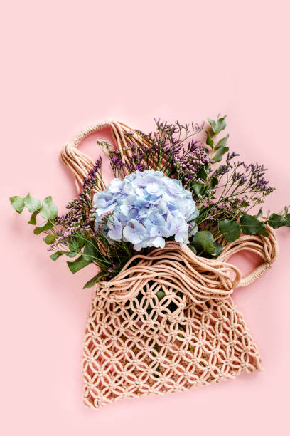 istock Beautiful bouquet of hydrangeas in a string, eco bag on white background. Flat lay, top view 1271572229