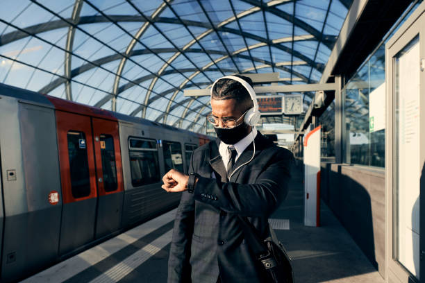 istock Handsome entrepreneur at the train station with a face mask 1271572663