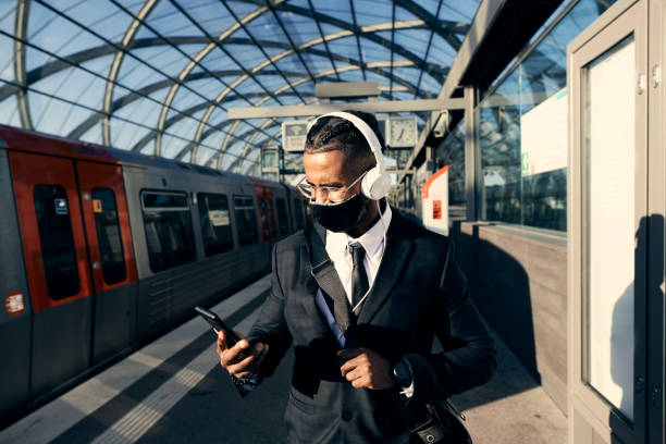 istock Handsome entrepreneur at the train station with a face mask 1271573565