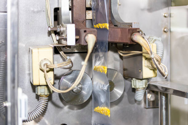 istock close up envelope plastic bag with goods product during seal by continuous vertical automatic sealer machine for industrial 1271573743
