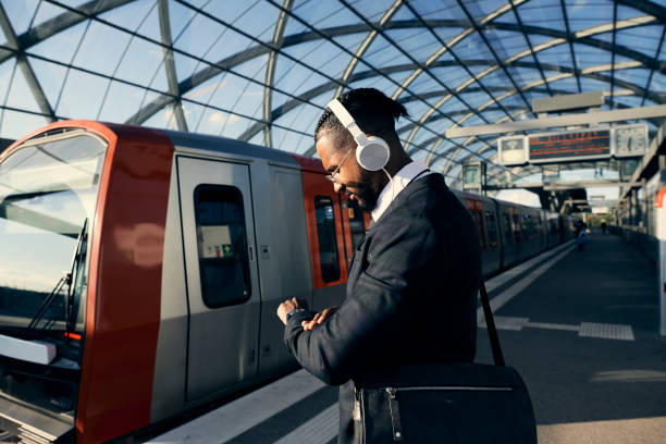 Young businessman at the train station, checking the time