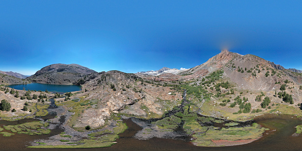 Where Odell Lake flows into a shallow bowl of a meadow.  An aerial VR image.