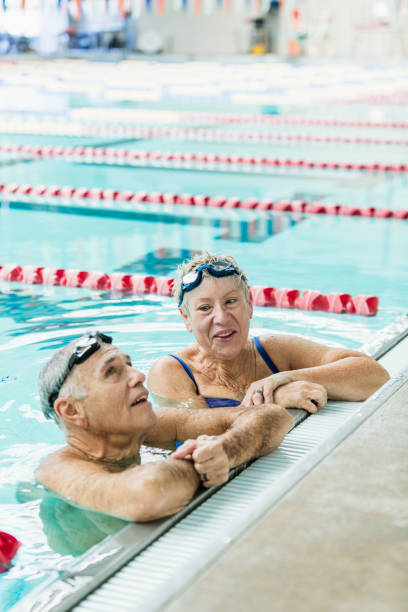 istock Senior couple exercising together, swimming laps 1271575713