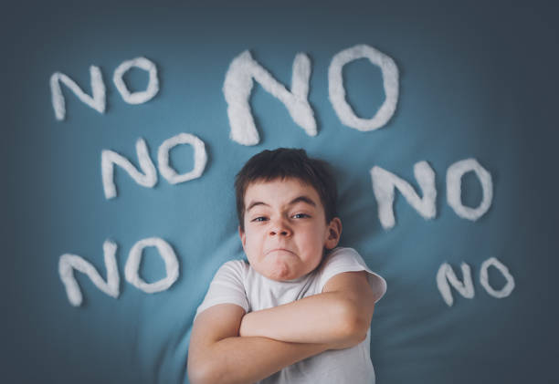 Bad boy on blue blanket background Bad boy on blue blanket background. Angry child with no words around. insurrection stock pictures, royalty-free photos & images