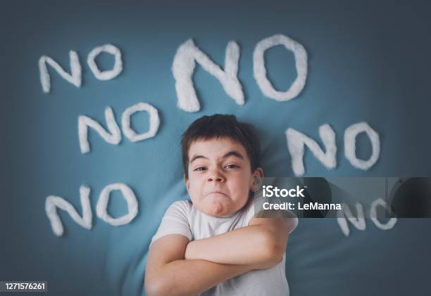 Bad Boy On Blue Blanket Background Stock Photo - Download Image Now - Rebellion, Child, Boys