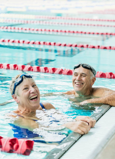 istock Senior couple exercising together, swimming laps 1271576391