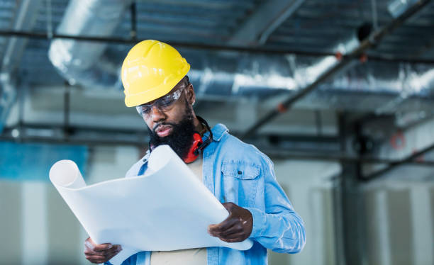 istock African-American construction worker with plans 1271577811