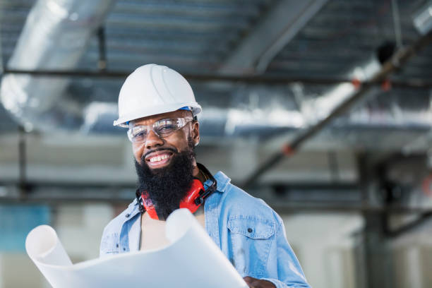 istock African-American construction worker with plans 1271577812