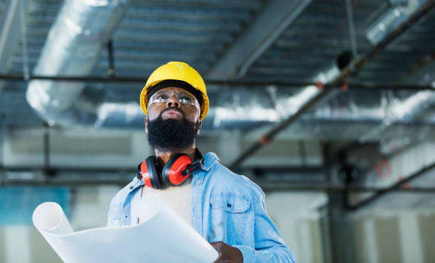 istock African-American construction worker with plans 1271577922