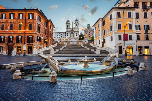 Piazza di Spagna square in Rome, Italy. Fontana della Barcaccia and Spanish Stepsat in Rome at sunrise.