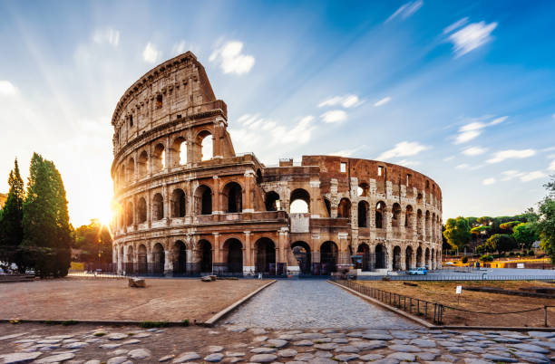 Colosseum in Rome during sunrise Colosseum in Rome during sunrise. Italy travel destination. Long exposure image with moving clouds. cobblestone photos stock pictures, royalty-free photos & images