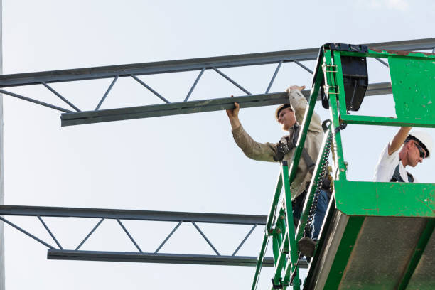 istock Steel workers installing roof trusses 1271582510