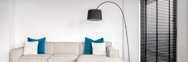 istock Simple beige sofa and lamp, panorama 1271582662