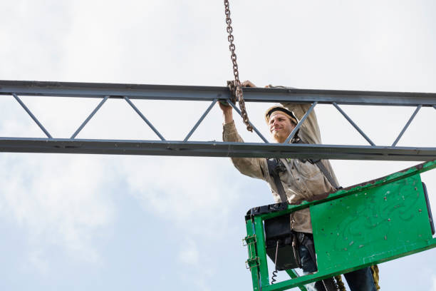 istock Construction worker on scissor lift with roof joist 1271583128
