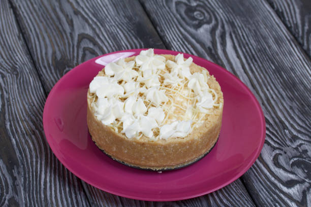 istock Cheesecake with white chocolate. On pine planks painted black and white. 1271588467