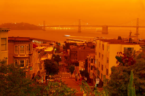 San Francisco During California Forest Fire A View towards Bay Bridge as dark orange sky from the surrounding forest fires covers the city. wildfire smoke stock pictures, royalty-free photos & images