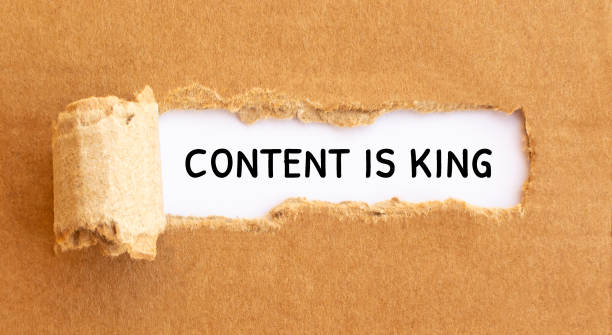 istock Text Content is King appearing behind torn brown paper 1271593385