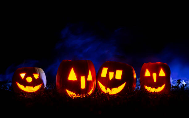 istock Halloween pumpkins over blue background with smoke with copy space. 1271593958