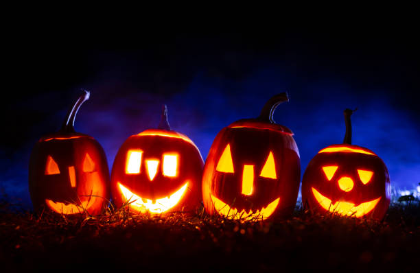 istock Halloween pumpkins over blue background with smoke. 1271593998