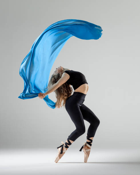 dancer with blue textile on the floor in motion