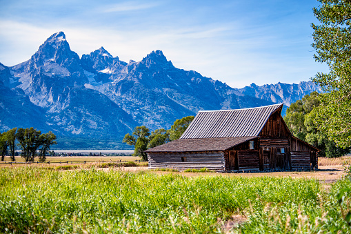An iconic abandoned barn framed by the beauty of the Teton range in Grand Teton National Park, Wyoming.