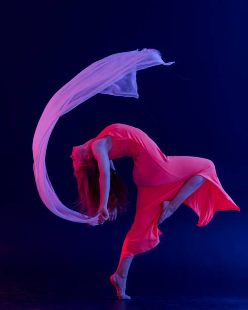 istock Dancer in red dress on black background 1271594950
