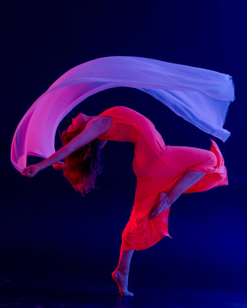 istock Dancer in red dress on black background 1271594960